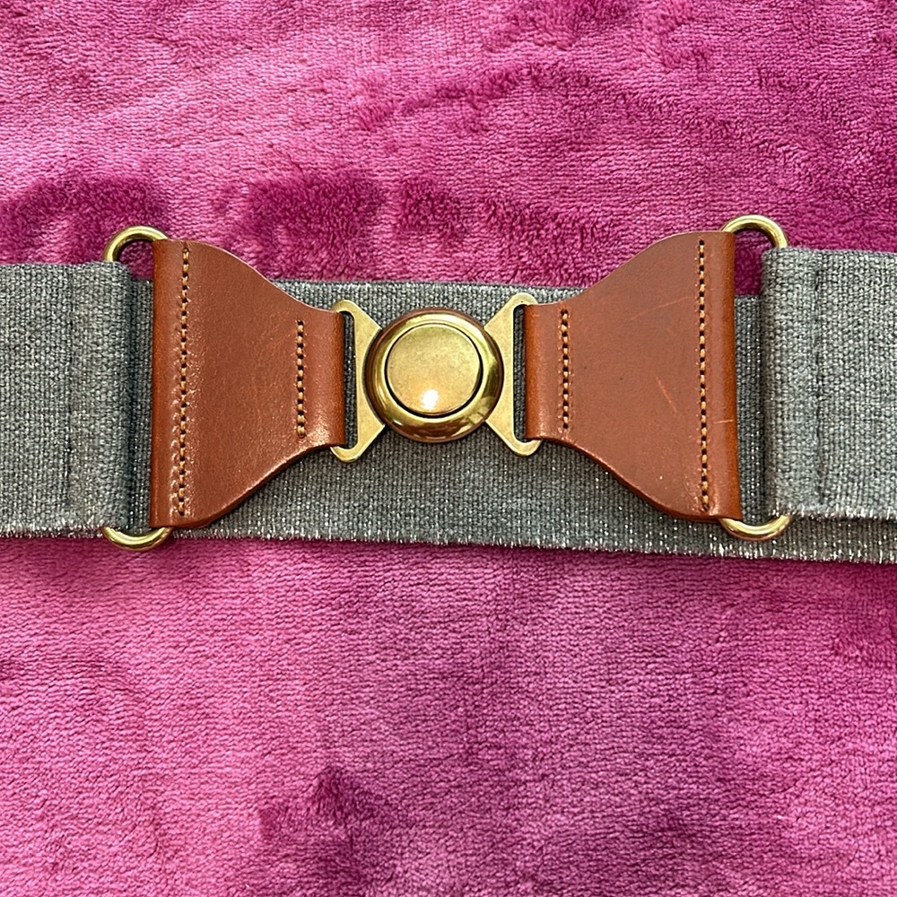 Grey stretchy belt size medium/ large with leather on sides and gold clasp